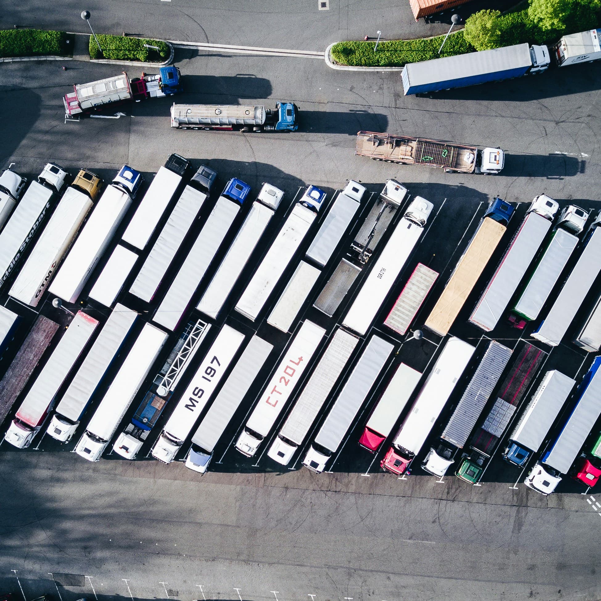 Aerial view of rows of semi-trailers parked in a freight yard