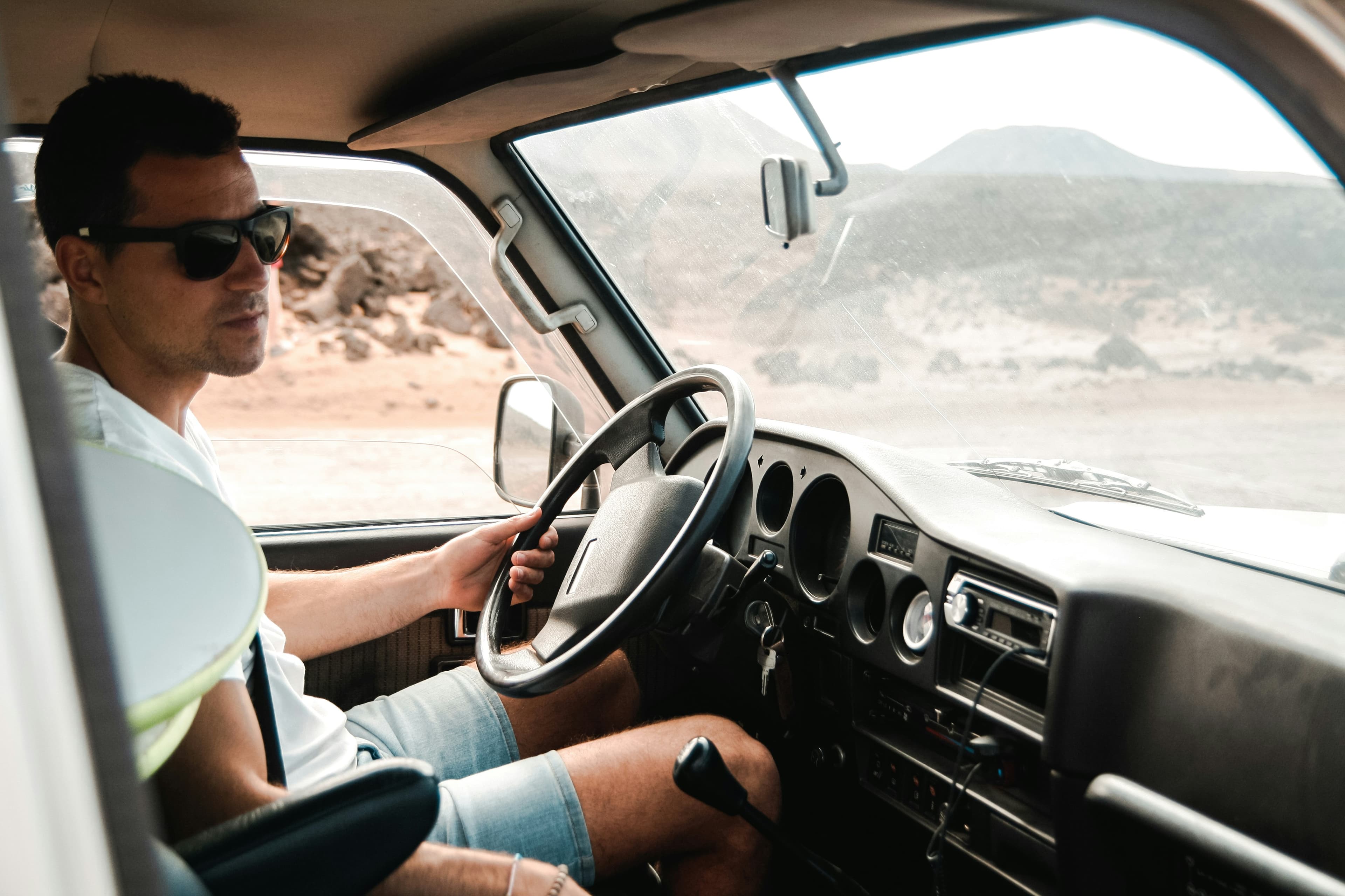A driver at the wheel inside a truck cab