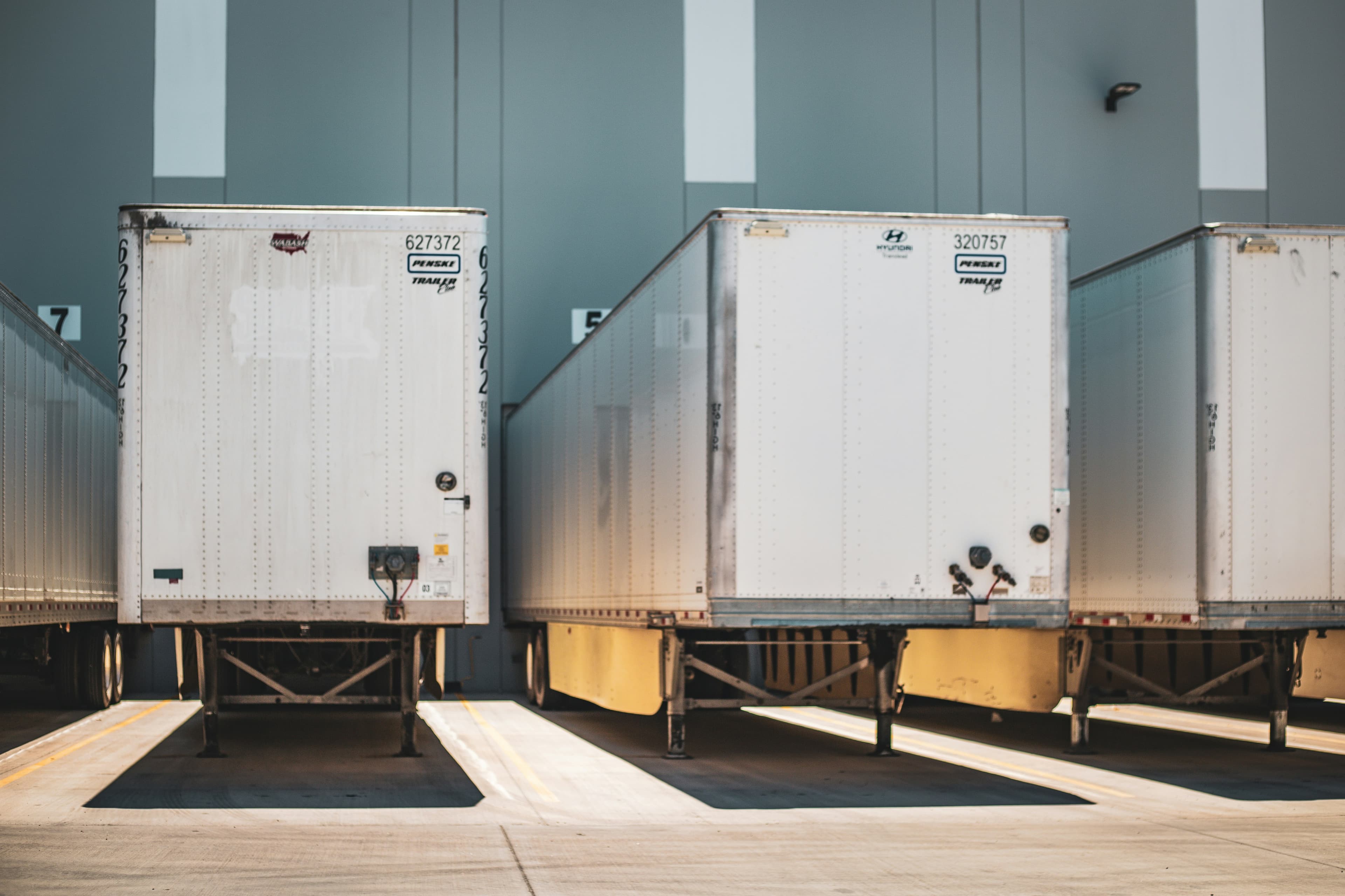White dry van trailers backed up side by side